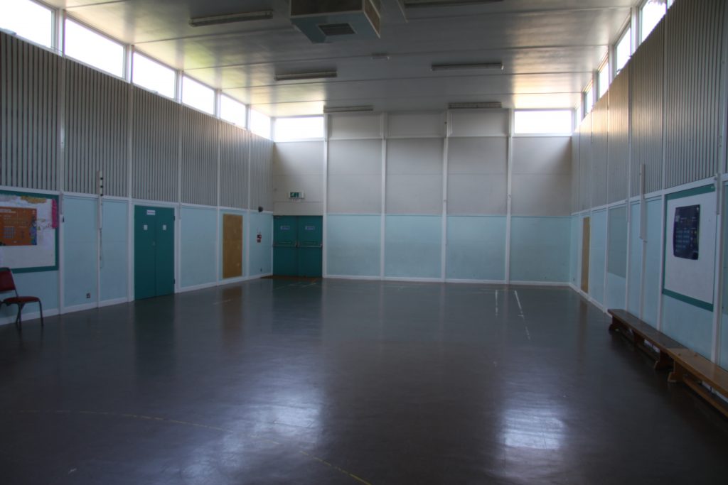 The Main Hall, from the South East Corner, showing fire exits doors to Car Park and double doors to storage area